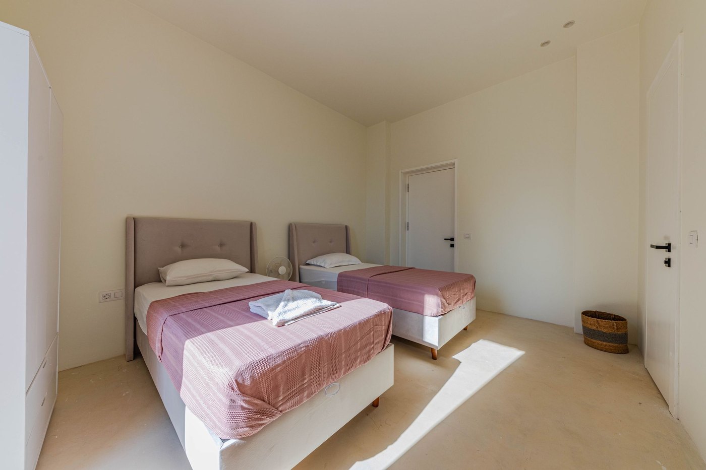 A furnished shared bedroom with two single beds at Peaceful Kare Path